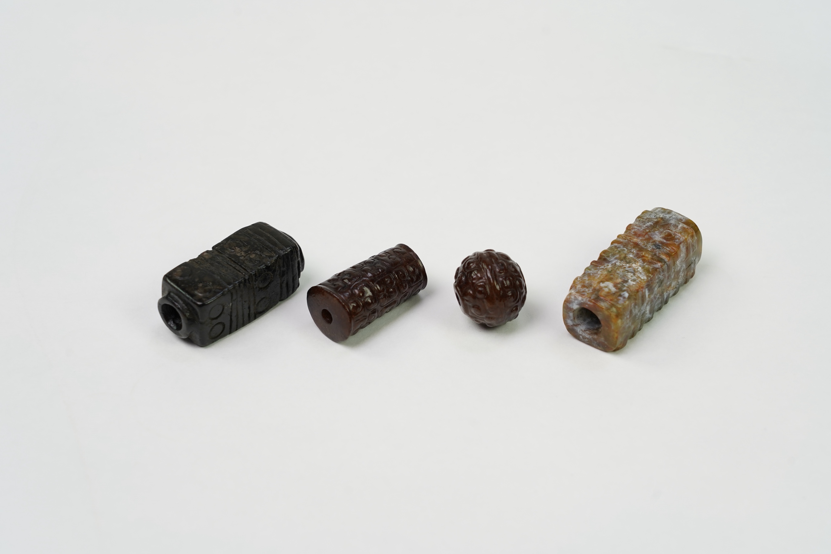 A group of four Chinese archaistic jade beads